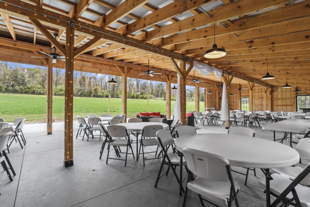 Our timber frame monoslope barn is more than just a beautiful structure; it is a marvel of rustic design. The monoslope roof—sloping in a single direction—provides a modern aesthetic that still honors the tradition of a timber frame building. This design choice sets us apart as a distinctive Maryland Barn Venue. The large timber beams provide unmatched architectural interest, which means less effort and expense for your décor. The natural wood, high ceilings, and stunning natural light create an ambiance that is effortlessly elegant.