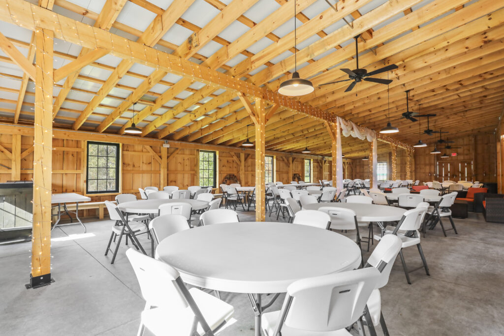 Experience the Magic of the Timber Frame Barn
The unique aesthetic of our venue enhances the mission and message of any organization.

Timber Frame Barn: Rich in character and ambiance, our barn provides a captivating backdrop for your event. The high ceilings and natural wood beams add an element of sophistication that elevates a standard fundraiser or meeting into a memorable occasion.
Picturesque Setting: Surrounded by the beauty of a Monoslope Timber Farm Pole Barn, your event will be unforgettable. The vast, serene landscape naturally reduces stress and encourages thoughtful discussion, making it an ideal Non-Profit Event Venue Clear Spring Maryland for team retreats and planning sessions.