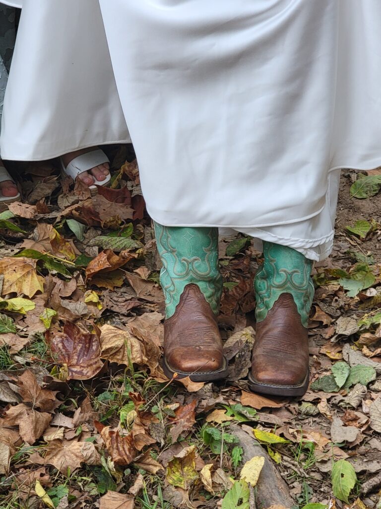 A close-up detail shot of Abigail’s rustic wedding cowboy boots at Timber Valley Farm Barn Rental Wedding and Event Venue 100 acre estate.