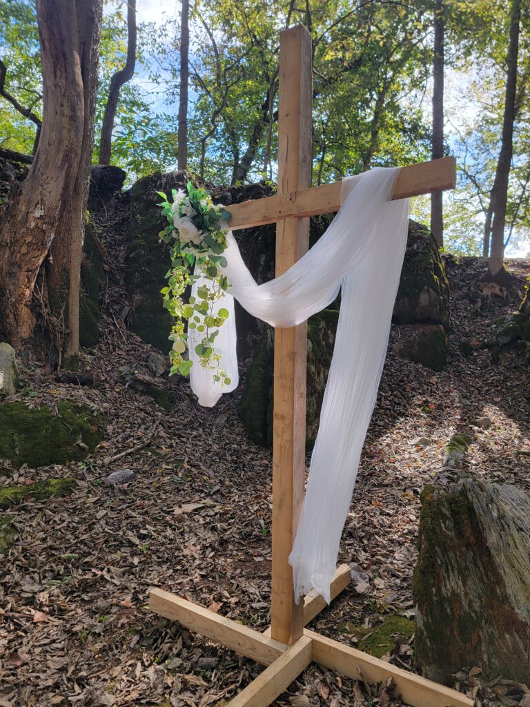 The Spiritual Architecture of God’s Cathedral at The Cove
There is a reason we call this specific site God’s Cathedral at The Cove. As an Outdoor Nature Wedding Venue, it utilizes the natural "pillars" of towering hardwoods and a "ceiling" of lush green leaves. When you stand at the altar, you are surrounded by the raw, unfiltered beauty of creation. This site offers a spiritual atmosphere that is often missing from modern wedding halls. The natural sunlight filters through the canopy, creating a "stained glass" effect that changes beautifully throughout the day, providing an ever-shifting and magical backdrop for your vows.