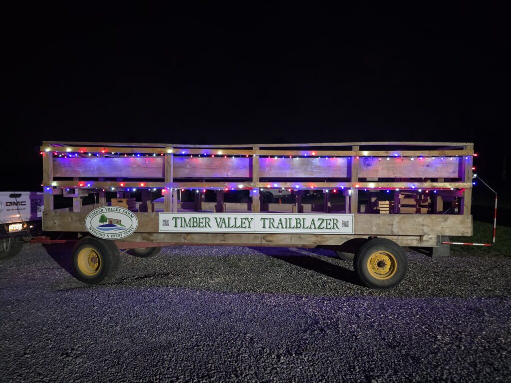 Autumn Wedding Venue Maryland Farm - Barn Rental near PA WV VA - Section 6: The Timber Valley Trailblazer Wagon Experience 🚜
Transportation at a farm wedding should be part of the fun! The Timber Valley Trailblazer Wagon is our custom-designed guest transport that adds a touch of rustic adventure. We take your guests on a scenic journey across our rolling 100-acre property, providing them with a "grand tour" of the farm before they arrive at the ceremony or reception.

For guests who may not be familiar with the beauty of rural Maryland, this ride is a highlight. It allows them to see the open rolling fields, the dense woods, and the carefully maintained landscape that Karen and Tom Grosh have spent years perfecting. It is an "official production" that adds a unique, memorable layer to your wedding day timeline. 🌾