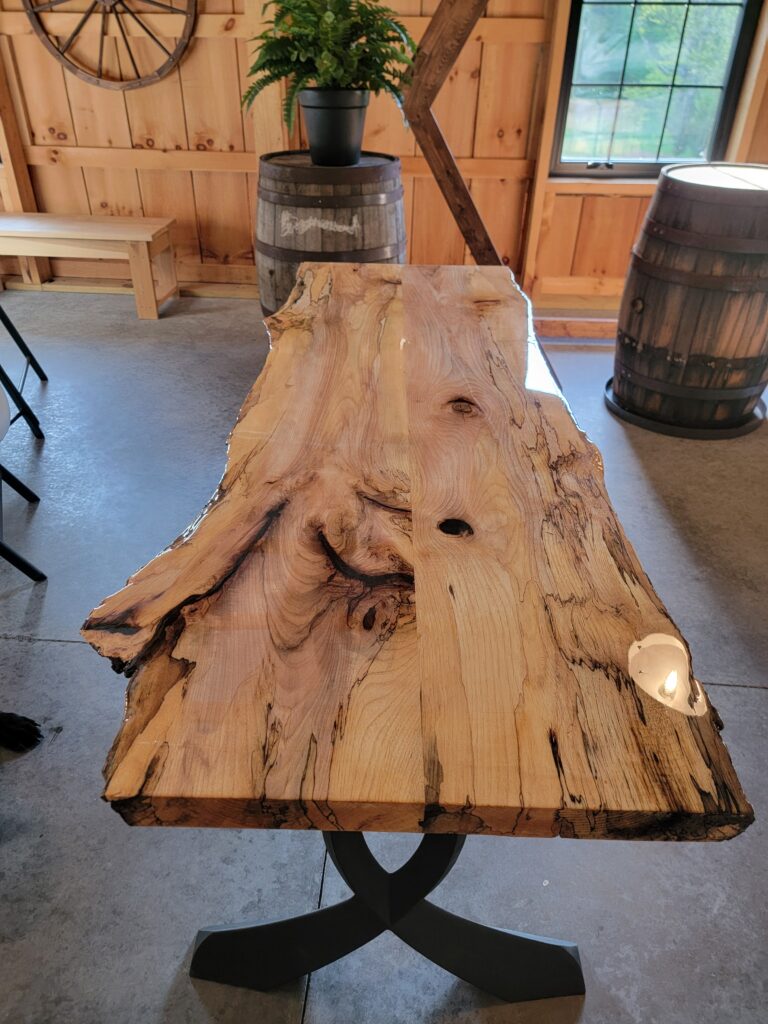 Seating and Custom Furniture
We provide ample seating and tables, including handcrafted live edge tables supported by authentic whiskey barrels. These unique pieces serve as both functional furniture and striking visual elements that elevate your event’s rustic charm. Our rustic bar and signature “Wedding Wagon” add character and create memorable focal points for guests.
