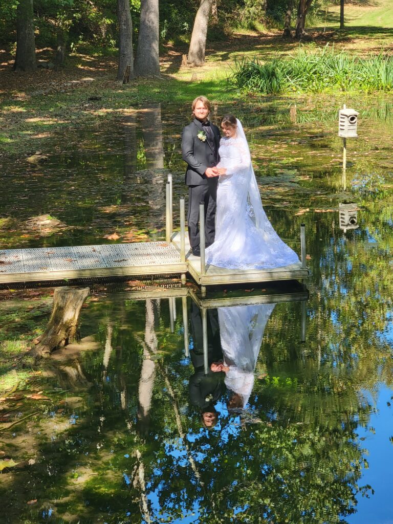 The Spring-Fed Pond: Reflective Beauty for Breathtaking Photos

One of Timber Valley’s hidden gems is the spring-fed pond, a tranquil oasis that offers endless photo opportunities. The crystal-clear water reflects the sky, trees, and joyful faces of your wedding party, creating images full of life and serenity. Many couples choose the pond for romantic portraits, group photos, or even a peaceful moment together before joining their guests. In every season, the pond’s beauty transforms—from the misty mornings of spring to the golden glow of autumn—ensuring your photos will be unique and unforgettable.
