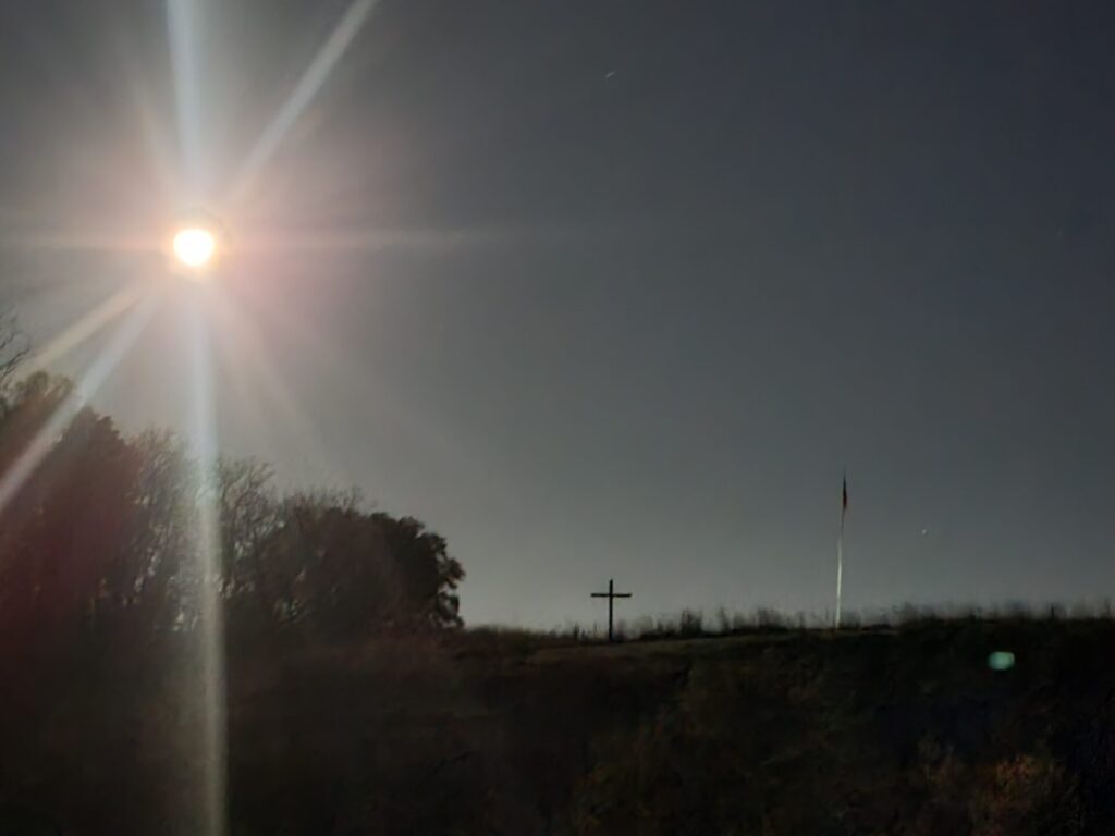 Moonlight shines above The Cross and American flag at Timber Valley Farm Barn Rental, creating a peaceful Moonrise in Western Maryland and a beautiful Maryland Moonlight Photography scene.