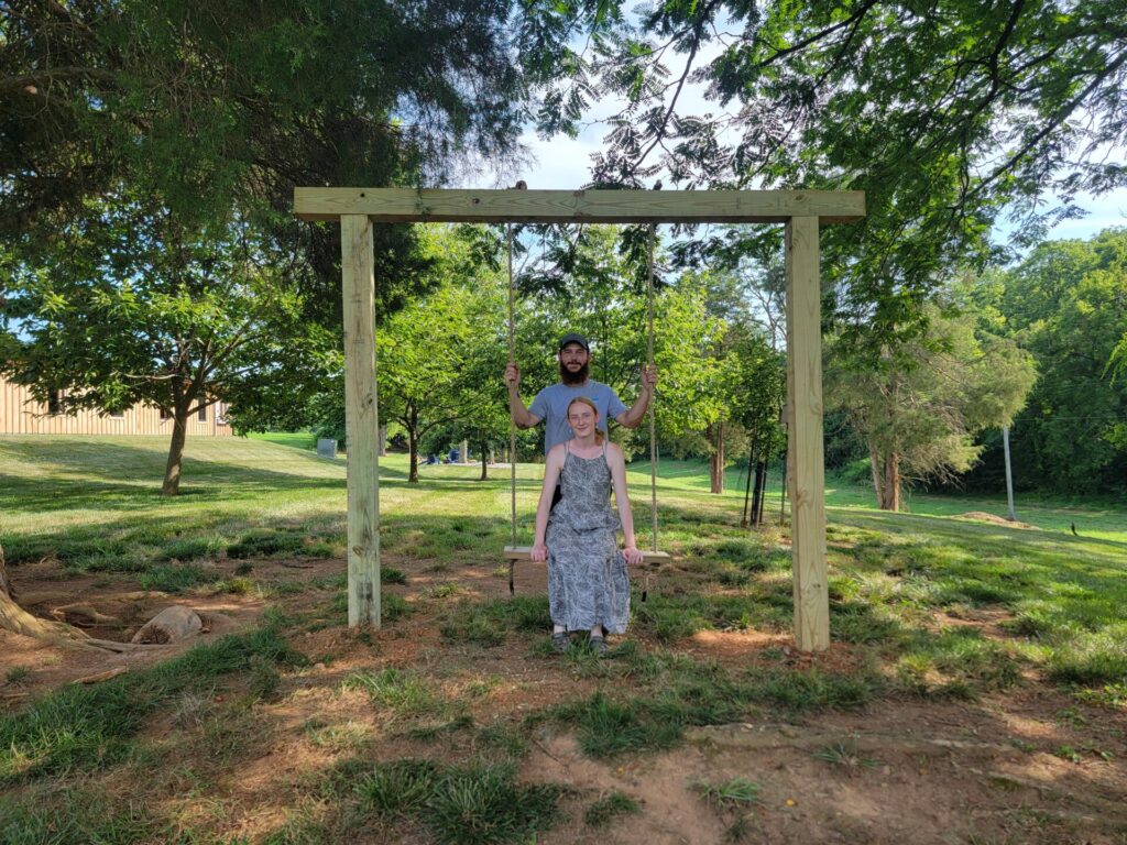 Couple enjoying the Timber Valley swing during a Private Wedding Venue Tour at Timber Valley Farm Barn Rental in Clear Spring, Maryland.
