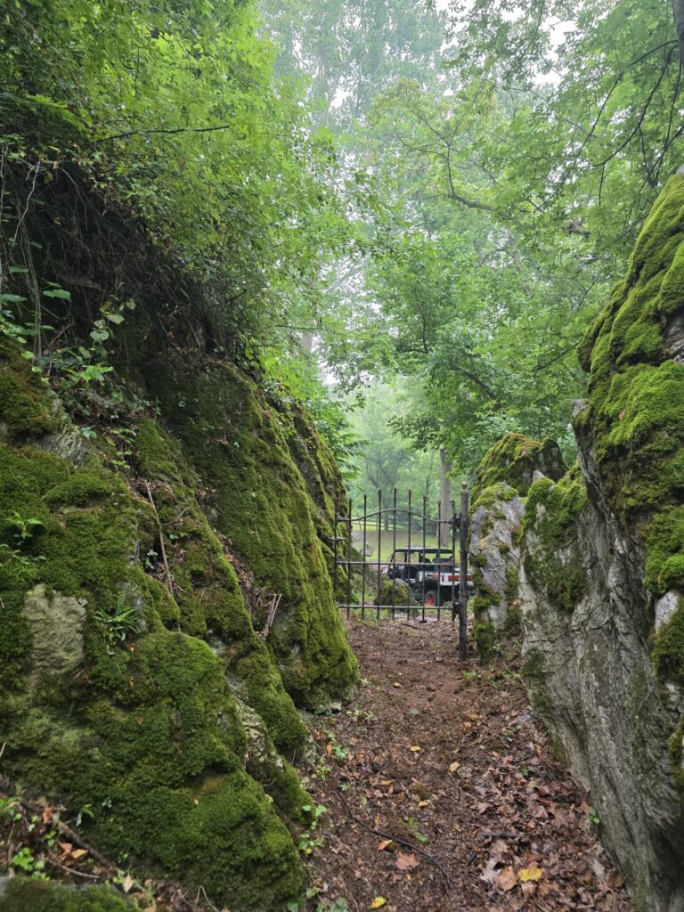 The Forgotten Gate to God's Cathedral at Timber Valley Farm Barn Rental, nestled between towering moss-covered boulders in God's Cathedral Maryland.