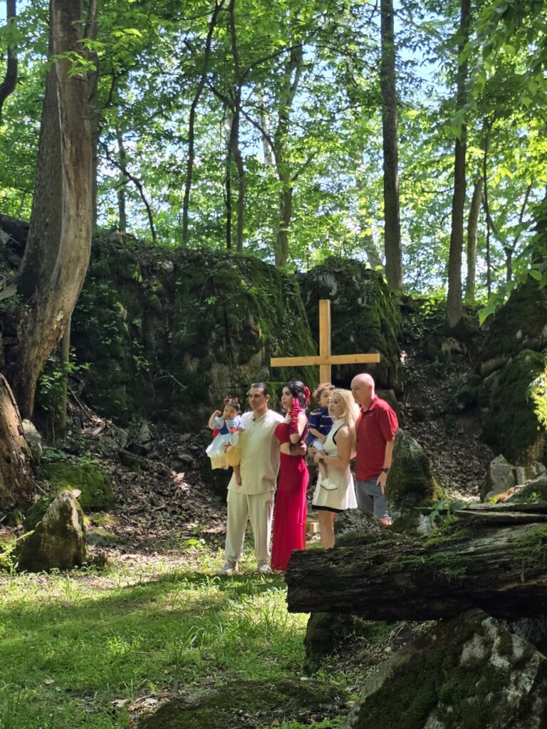 A family comes together at God's Cathedral to pray over the family before the start of the family event at Timber Valley Farm Barn Rental.