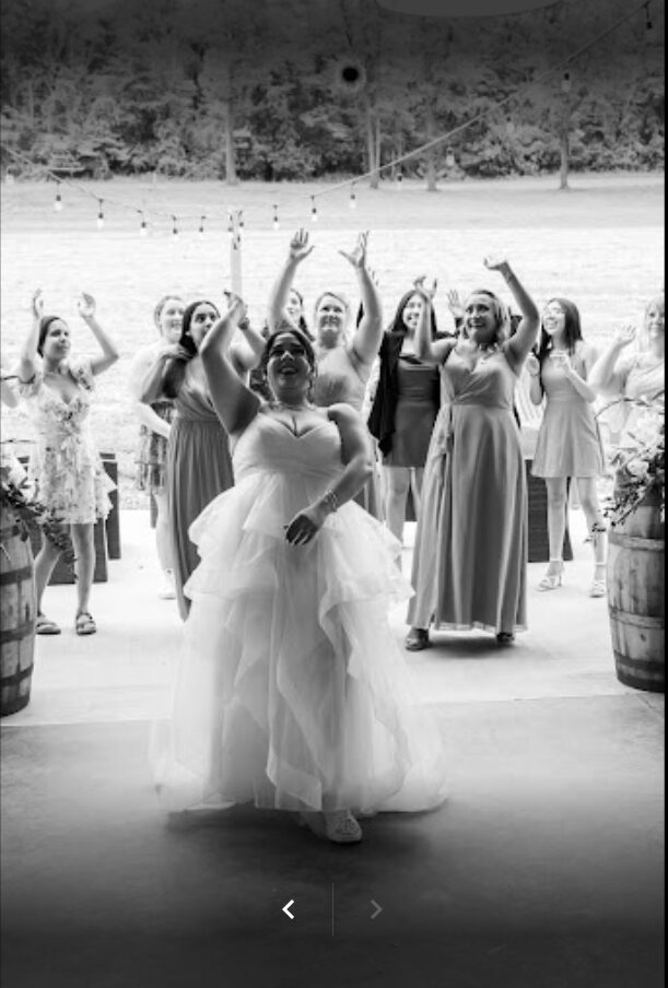Bride tossing her bouquet during the Wedding Day Timeline at Timber Valley Farm Barn Rental in Clear Spring, Maryland.
