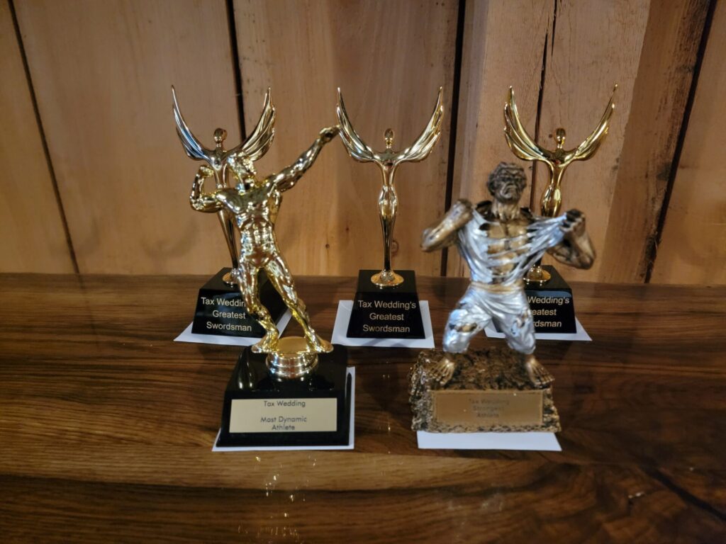 Strong Man Competition trophies displayed during a Friday wedding rehearsal celebration at Timber Valley Farm Barn Rental in Western Maryland.