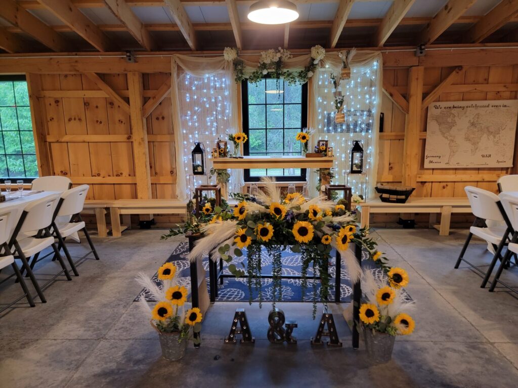 Beautifully decorated wedding head table during the reception at Timber Valley Farm Barn Rental in Clear Spring, Maryland.