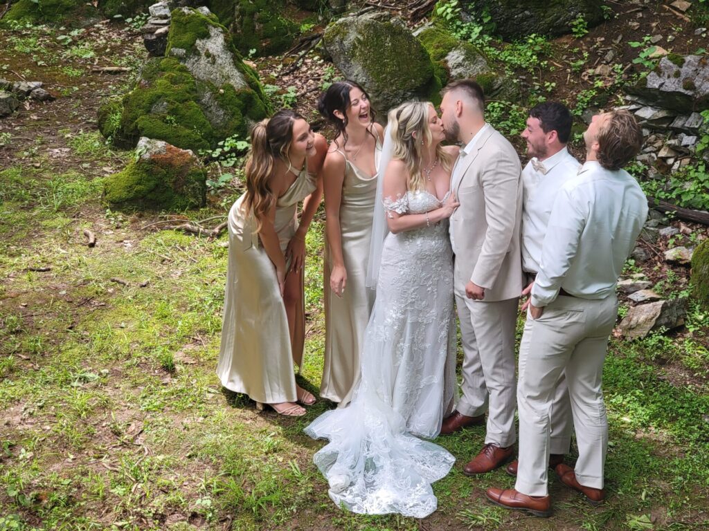 Bride and wedding party sharing a joyful moment during the Wedding Day Timeline at Timber Valley Farm Barn Rental in Clear Spring, Maryland.
