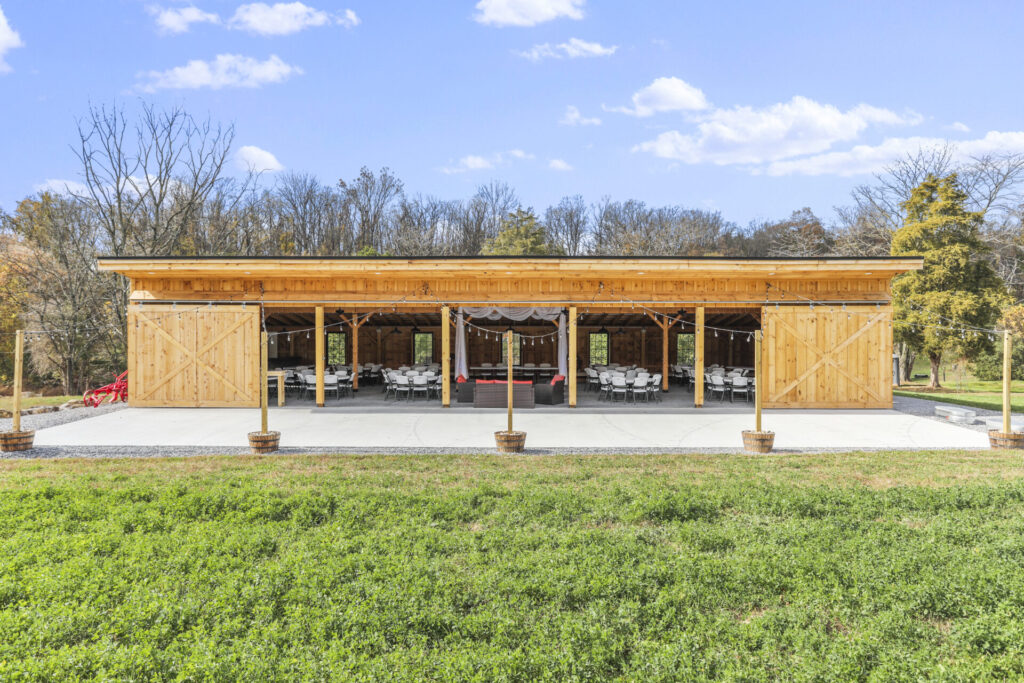 Timber-frame barn with open doors and reception seating at Timber Valley Farm Barn Rental in Clear Spring Maryland