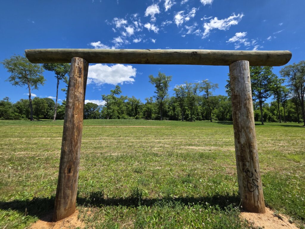 Outdoor Wedding Ceremony Ideas. Wedding Ceremony Arbor handcrafted from massive timber logs at Timber Valley Farm Barn Rental in Clear Spring, Maryland.