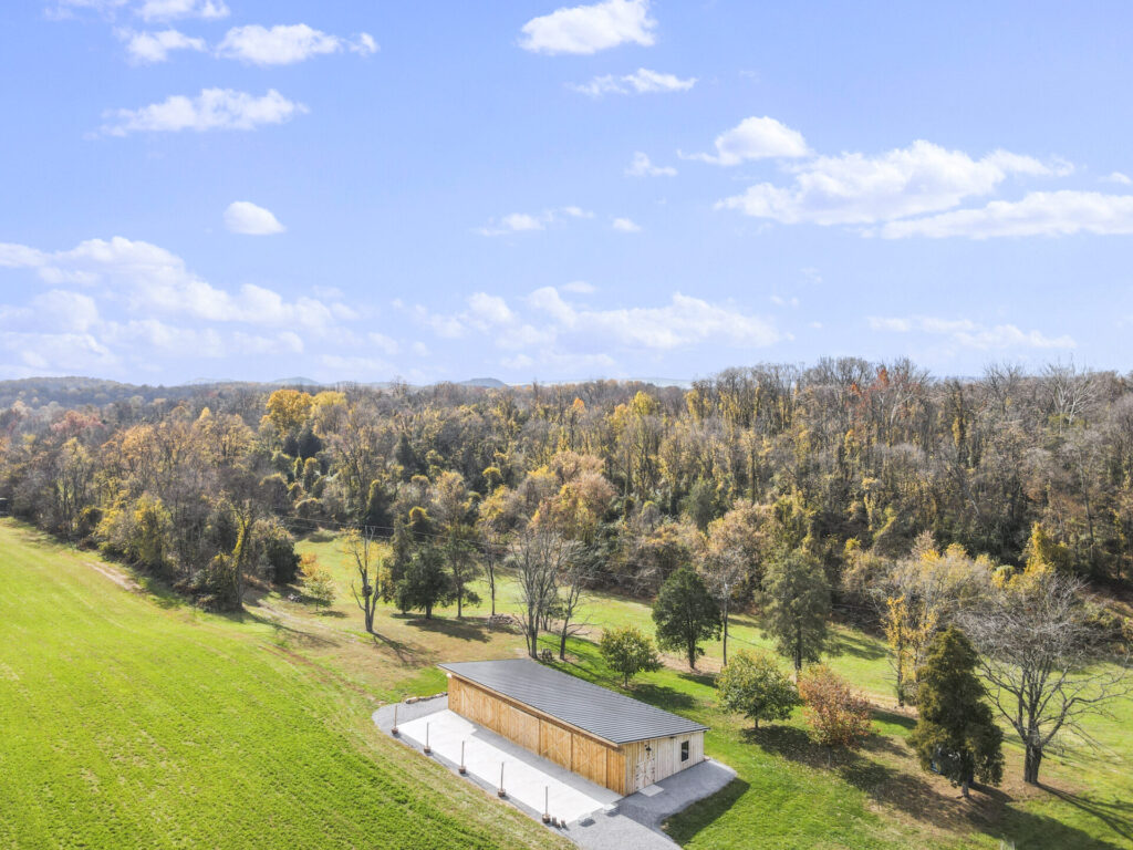 Family Lifestyle Photography Maryland setting with Timber Valley Farm Barn Rental, open fields, wooded hillsides, and timber-frame barn