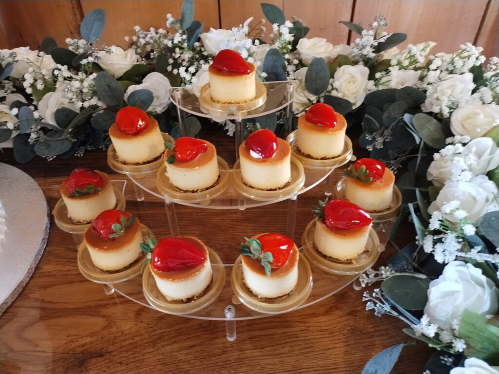 Wedding Guest Experience Maryland with individual strawberry-topped cheesecakes and floral decorations at a Timber Valley Farm Barn Rental reception