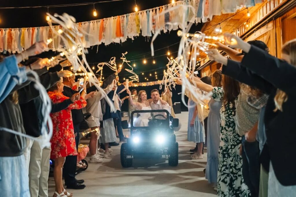 Wedding Reception Ideas featuring the bride and groom's grand send-off in a Jeep beneath café string lights at Timber Valley Farm Barn Rental in Clear Spring, Maryland.