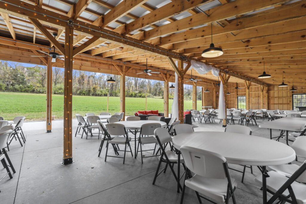 Timber Valley Virtual Tour showing the open-air timber-frame barn interior with tables seating and views of the lawn