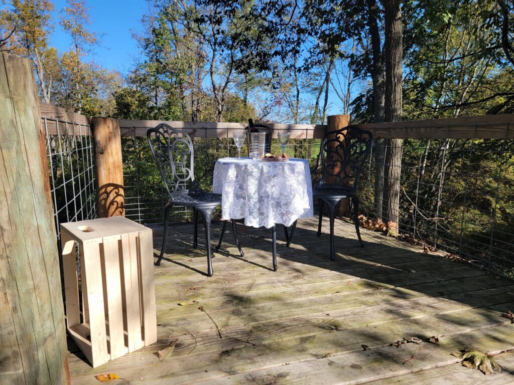 Proposal Photography Western Maryland setting with a private table for two on a wooded deck at Timber Valley Farm Barn Rental