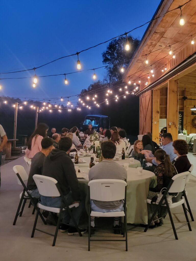 Wedding Ceremony Venue Planning continues into an outdoor wedding reception under string lights at Timber Valley Farm Barn Rental in Clear Spring, Maryland.