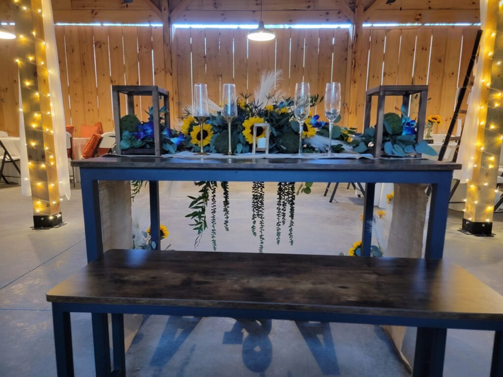 Wedding Reception Ideas featuring a beautifully decorated live-edge sweetheart table inside the handcrafted timber frame barn at Timber Valley Farm Barn Rental in Clear Spring, Maryland.