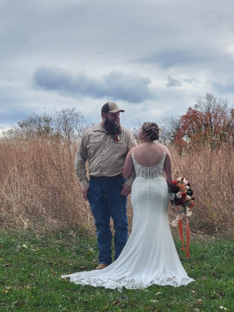 Fall Wedding Backdrop with bride and groom surrounded by tall grasses and autumn foliage at Timber Valley Farm Barn Rental in Clear Spring, Maryland.