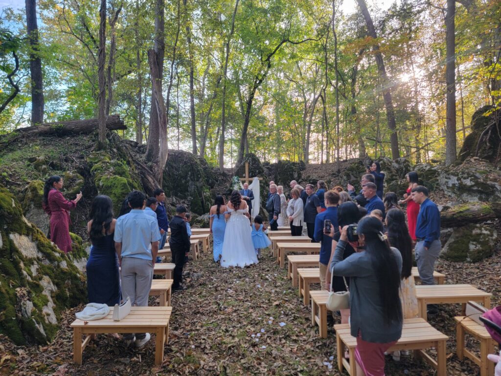Wedding Ceremony Tips featuring a bride walking down the aisle during an outdoor wedding ceremony at Timber Valley Farm Barn Rental in Clear Spring, Maryland.