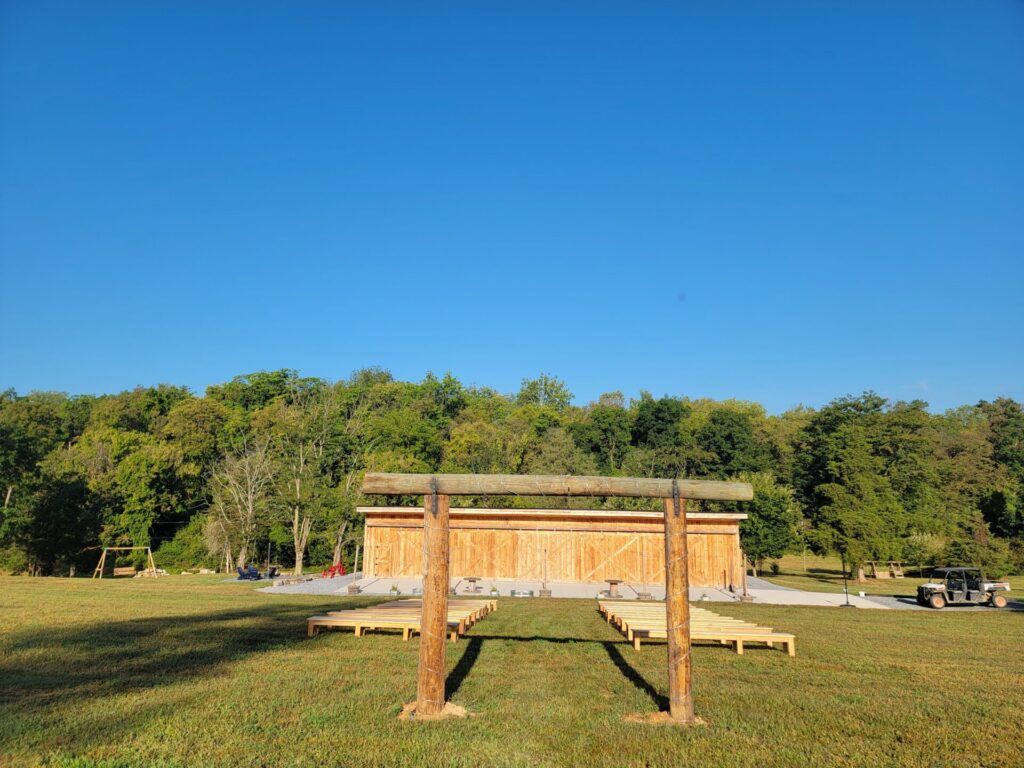Outdoor Wedding Ceremony Ideas. Handcrafted timber wedding arbor overlooking the outdoor ceremony space at Timber Valley Farm Barn Rental in Clear Spring, Maryland.