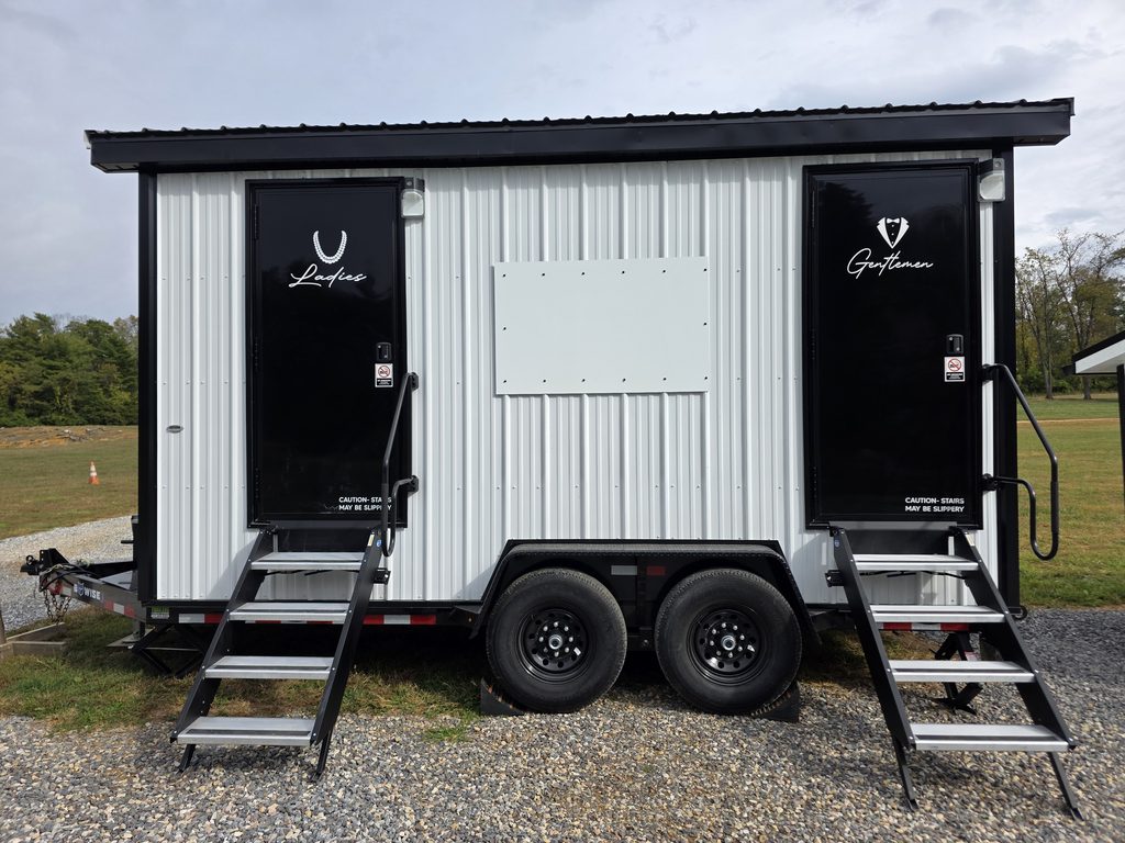 Luxury restroom trailer with separate ladies’ and gentlemen’s entrances available as an optional wedding and event upgrade at Timber Valley Farm Barn Rental in Clear Spring, Maryland.