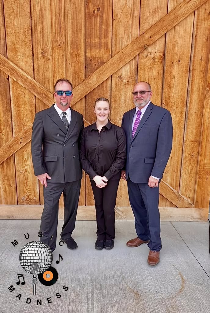 The Music Madness team standing in front of the wooden barn doors at Timber Valley Farm Barn Rental in Maryland