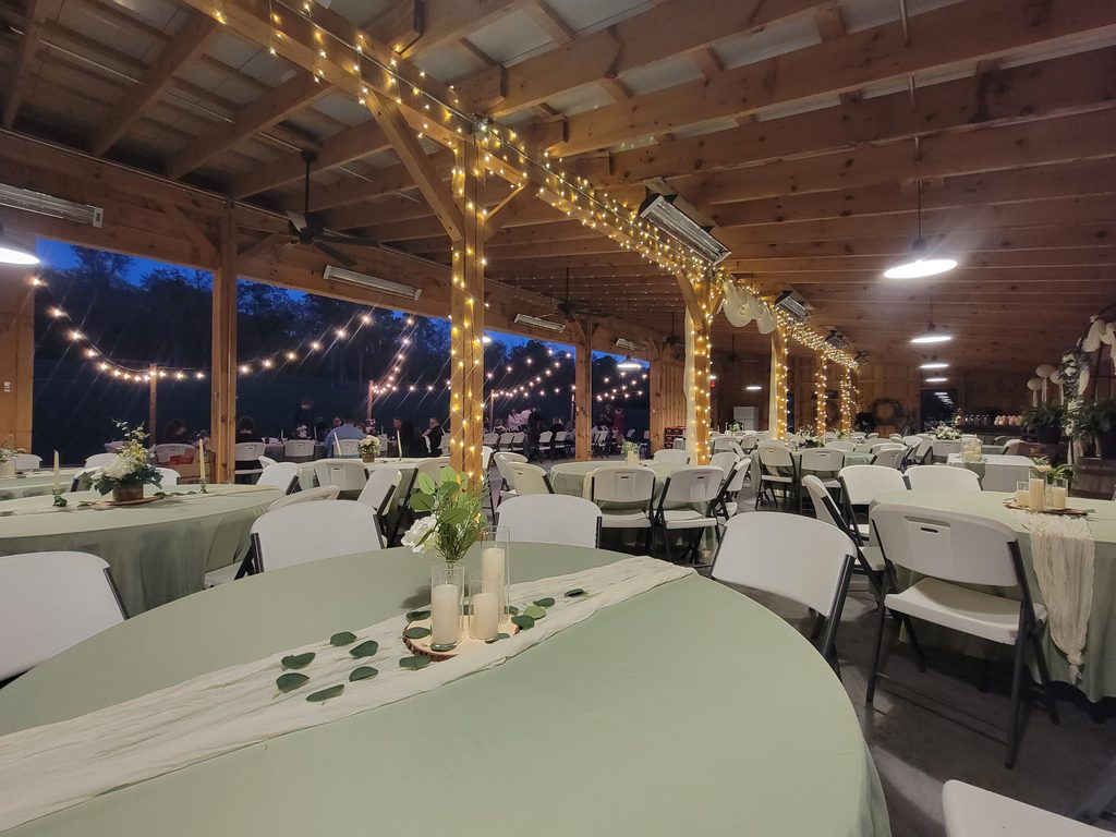 Rustic Maryland barn wedding reception with glowing string lights at Timber Valley Farm Barn Rental in Clear Spring, Maryland