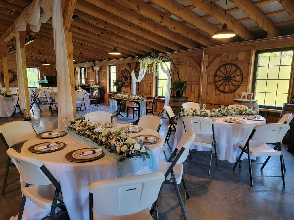 Maryland Barn Wedding Packages. Rustic Maryland barn wedding reception with floral centerpieces at Timber Valley Farm Barn Rental in Clear Spring, Maryland